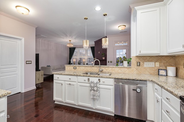 kitchen featuring dishwasher, white cabinets, hanging light fixtures, and sink