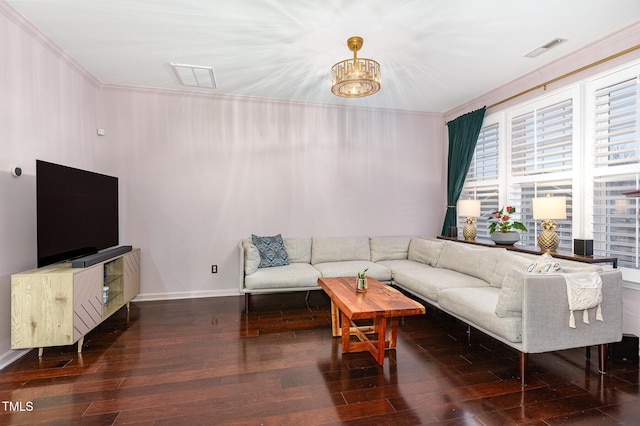 living room featuring a notable chandelier, crown molding, and dark wood-type flooring