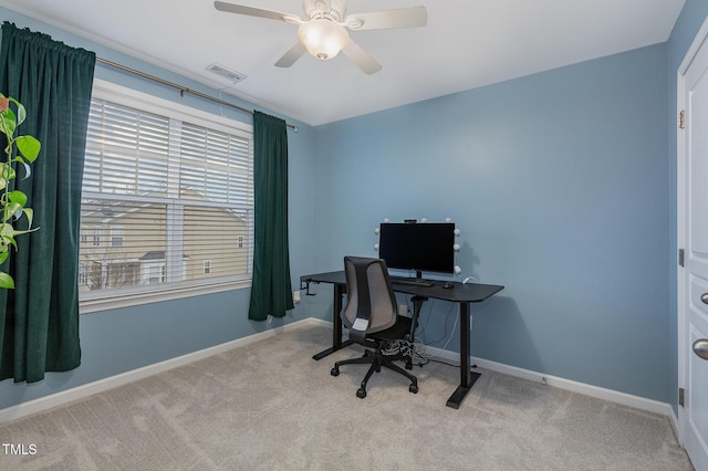 office area with light carpet, a wealth of natural light, and ceiling fan