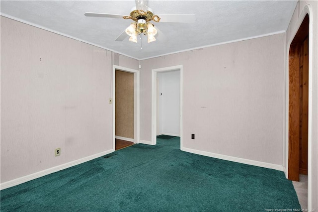 unfurnished bedroom featuring dark colored carpet, ceiling fan, and ornamental molding