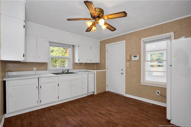 kitchen featuring white cabinets, white refrigerator, sink, dark hardwood / wood-style floors, and ceiling fan