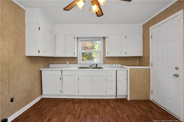 kitchen featuring ornamental molding, ceiling fan, sink, white cabinets, and dark hardwood / wood-style floors