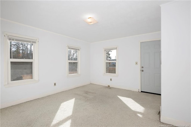 unfurnished room featuring light colored carpet and a wealth of natural light