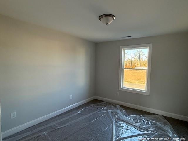 empty room featuring visible vents and baseboards