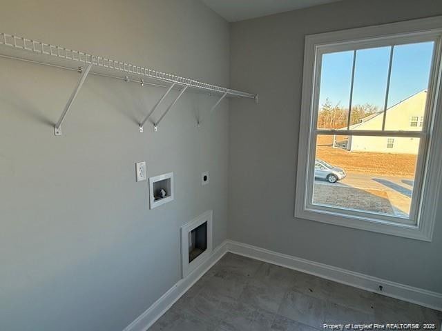 laundry room with laundry area, washer hookup, electric dryer hookup, and baseboards