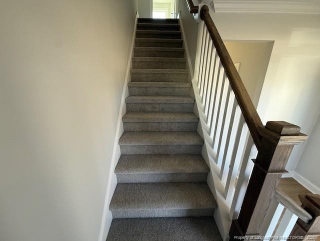 stairway featuring baseboards