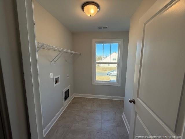 clothes washing area featuring laundry area, visible vents, baseboards, hookup for a washing machine, and hookup for an electric dryer