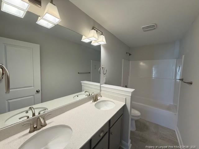 full bath with shower / bathing tub combination, a sink, and toilet