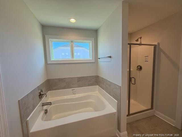 full bath featuring a garden tub and a shower stall