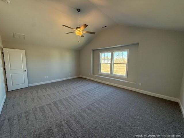 interior space with carpet floors, visible vents, vaulted ceiling, and baseboards