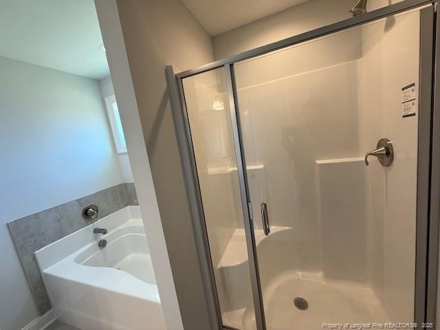 full bathroom with a stall shower and a bath