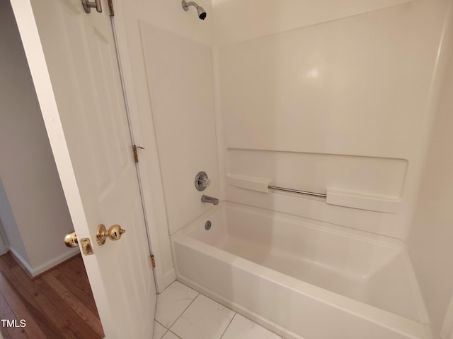 bathroom with baseboards and shower / bathtub combination