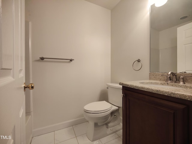 full bathroom featuring toilet, tile patterned flooring, baseboards, and vanity