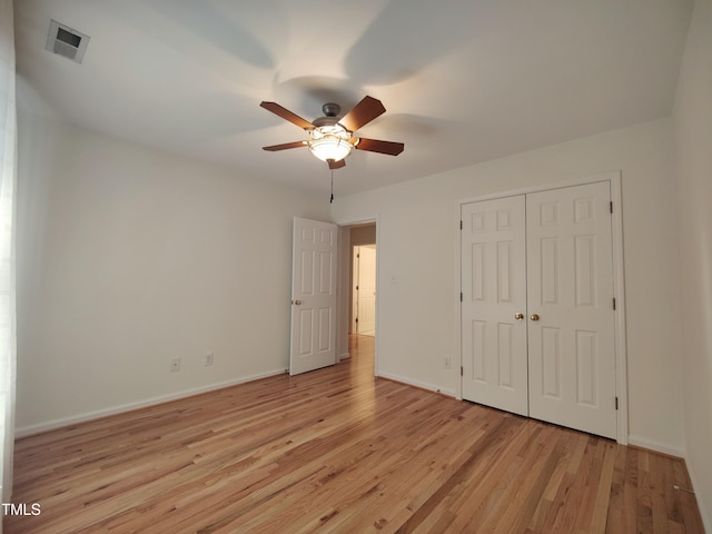 unfurnished bedroom with a ceiling fan, visible vents, baseboards, a closet, and light wood finished floors