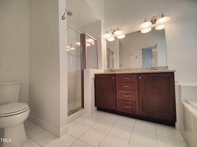 bathroom with a sink, a shower stall, toilet, and double vanity