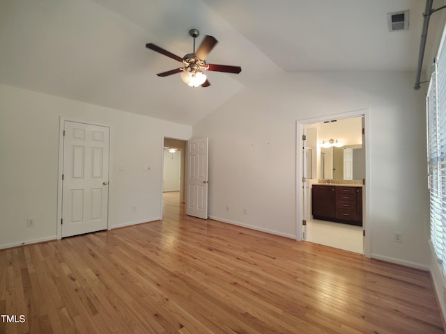 unfurnished bedroom with ensuite bathroom, visible vents, baseboards, vaulted ceiling, and light wood finished floors