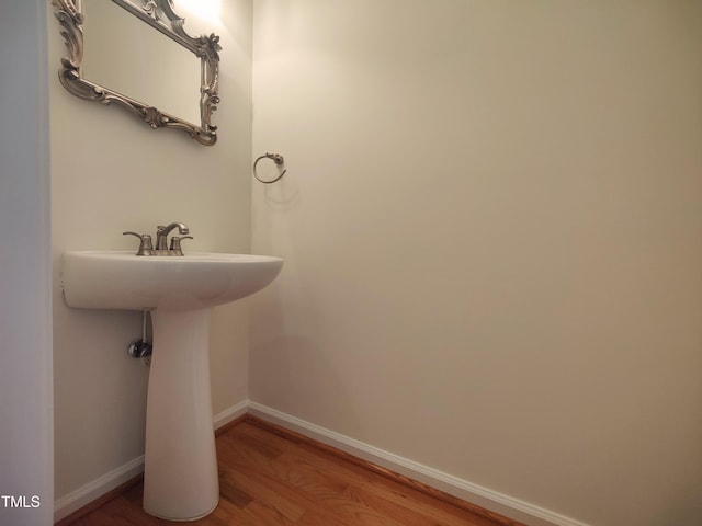 bathroom featuring baseboards and wood finished floors