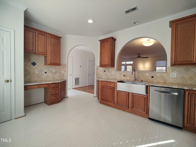 kitchen with arched walkways, a sink, visible vents, stainless steel dishwasher, and brown cabinets