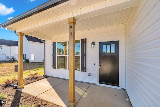 view of exterior entry with covered porch