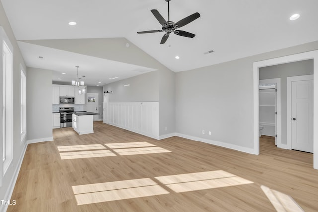 unfurnished living room with light hardwood / wood-style floors, vaulted ceiling, and ceiling fan