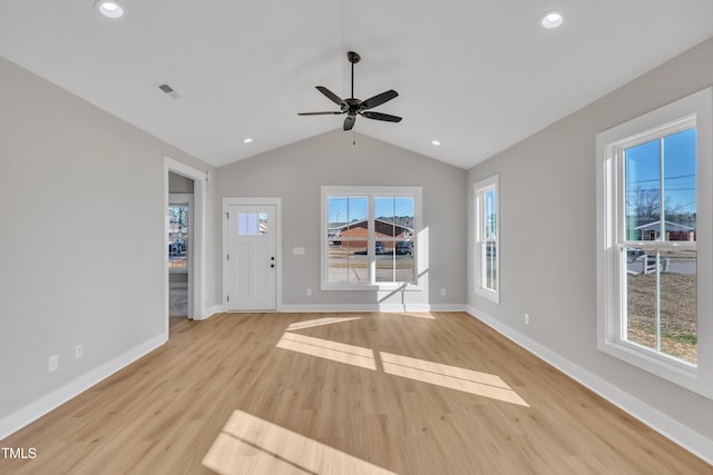 unfurnished living room with light wood-type flooring, ceiling fan, and lofted ceiling