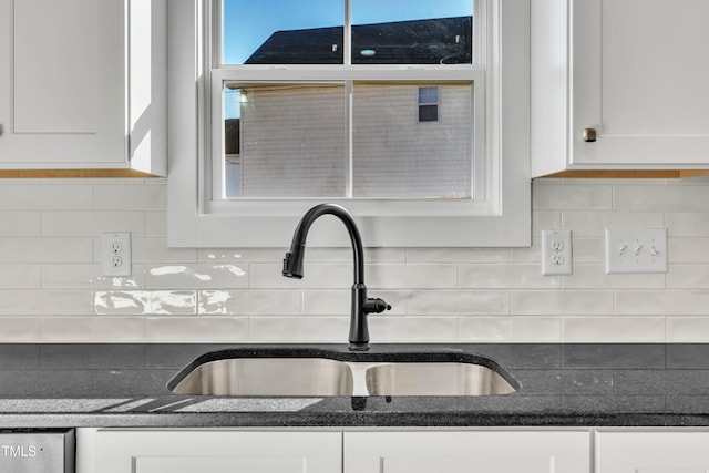 details featuring white cabinetry, sink, and tasteful backsplash