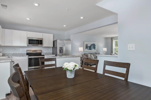 dining area with dark hardwood / wood-style flooring