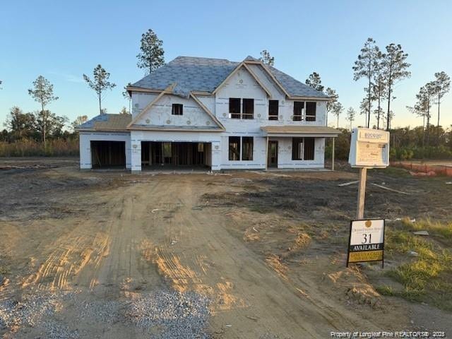 property in mid-construction featuring driveway and an attached garage