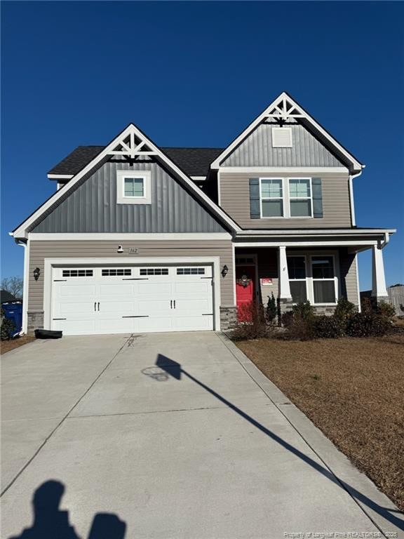 craftsman inspired home with covered porch and a garage