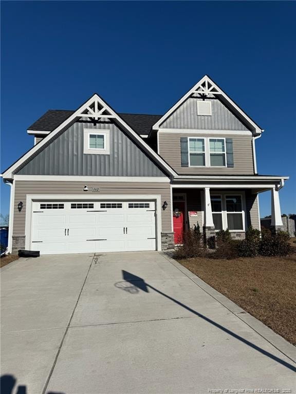 craftsman-style house featuring covered porch and a garage