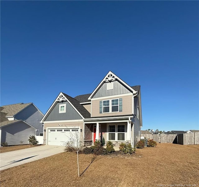 craftsman-style home featuring fence, board and batten siding, and concrete driveway