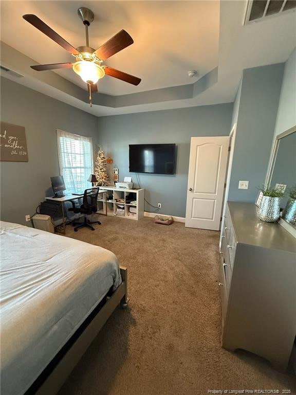 bedroom featuring ceiling fan, carpet, a raised ceiling, and visible vents