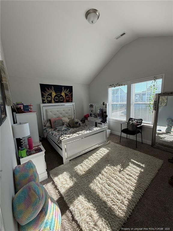 carpeted bedroom featuring vaulted ceiling, visible vents, and baseboards