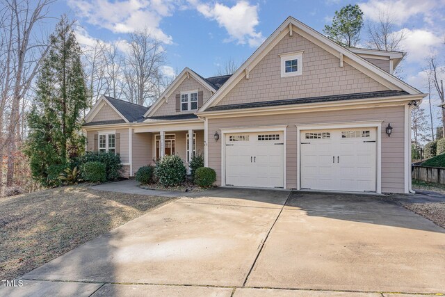 craftsman-style house featuring a porch and a garage