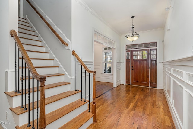 entryway featuring ornamental molding and hardwood / wood-style floors