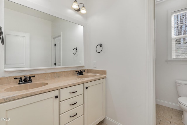 bathroom featuring vanity and toilet