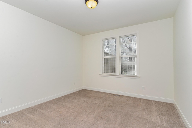 empty room featuring light colored carpet