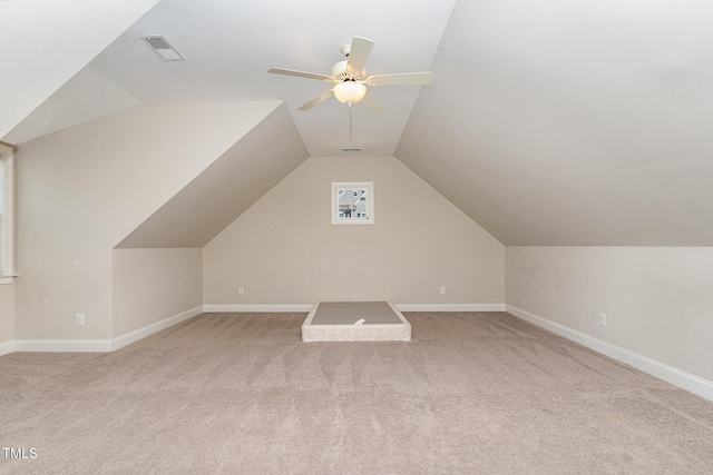 additional living space featuring light carpet, vaulted ceiling, and ceiling fan