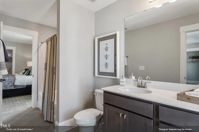 bathroom with tile patterned flooring, a shower with shower curtain, toilet, and vanity