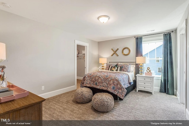 bedroom featuring carpet flooring, baseboards, a walk in closet, and visible vents