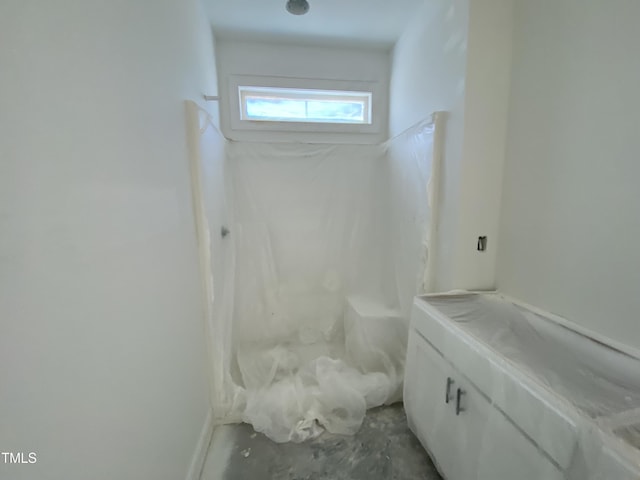 bathroom with concrete flooring