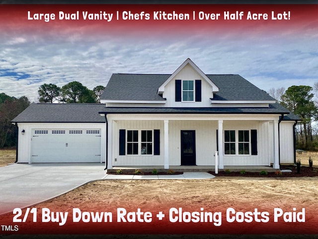 modern farmhouse featuring an attached garage, driveway, a porch, and board and batten siding