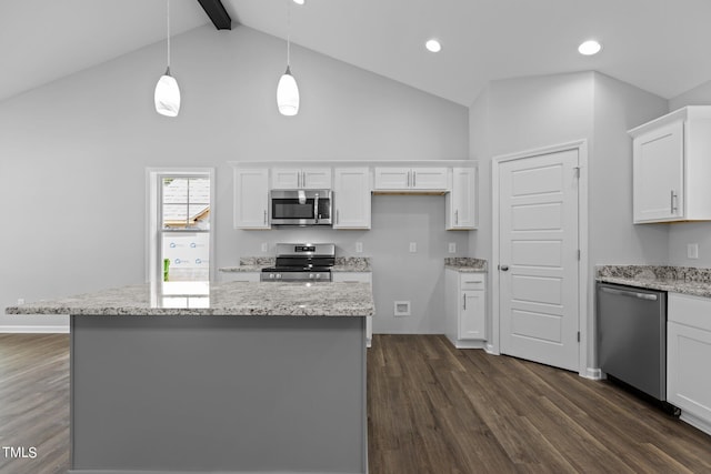 kitchen with light stone countertops, white cabinetry, pendant lighting, and appliances with stainless steel finishes