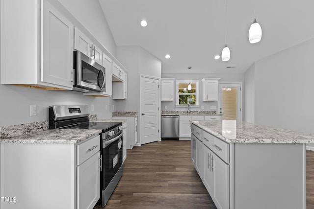 kitchen featuring hanging light fixtures, appliances with stainless steel finishes, a kitchen island, dark hardwood / wood-style flooring, and white cabinetry