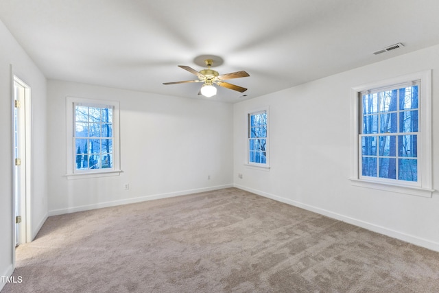 carpeted spare room with ceiling fan