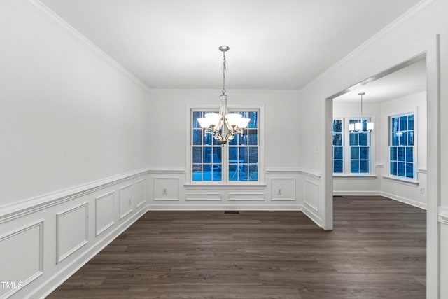 unfurnished dining area with a chandelier, dark hardwood / wood-style floors, and ornamental molding