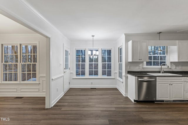 kitchen with dishwasher, white cabinets, sink, hanging light fixtures, and ornamental molding