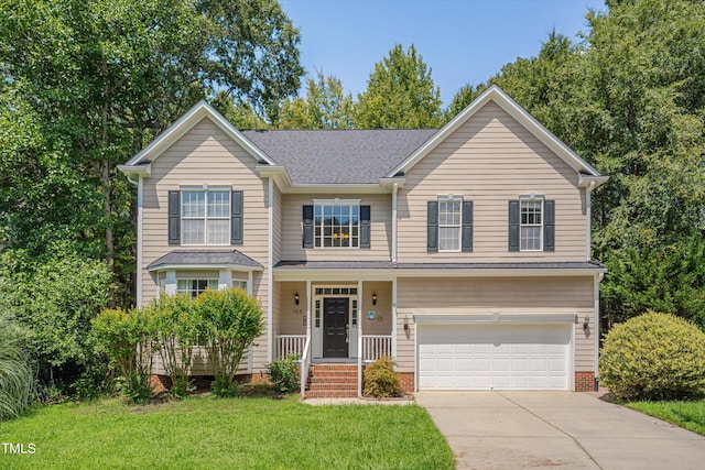 view of front of property featuring a front yard and a garage