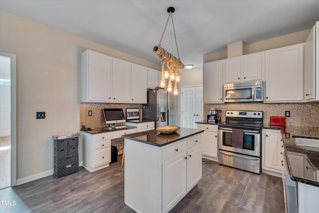 kitchen featuring white cabinets, appliances with stainless steel finishes, a center island, and pendant lighting