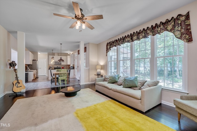 living room with dark hardwood / wood-style floors and ceiling fan